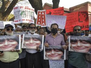 Activists belonging to various human rights organisations hold placards as they stage a demonstration against the arrest of the activist Disha Ravi by Delhi police for her alleged involvement in the instigation of violence during the farmers protest on India's Republic Day, in Bangalore on February 15, 2021. Manjunath Kiran / AFP