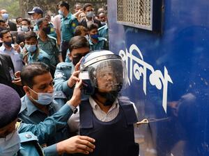Police escort a convicted man (R) after a Bangladesh anti-terrorism court sentenced five Islamist extremists to death over the brutal murder of Avijit Roy, a Bangladeshi-US writer and rights activist, in Dhaka on February 16, 2021. sazzad hossain / AFP