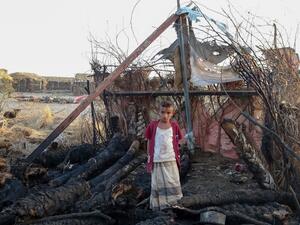 A displaced Yemeni youth stands in the midst of calcined wooden poles after a fire broke out in a shelter in the war-ravaged western Hodeida province, on February 16, 2021. Khaled Ziad / AFP