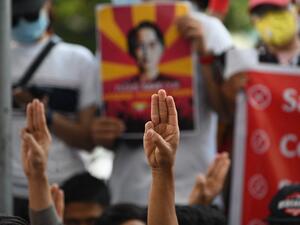 Protesters hold up the three finger salute during a demonstration against the military coup in Yangon on February 17, 2021. Sai Aung Main / AFP