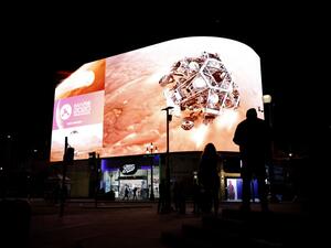 An image showing the simulation of the landing of NASA's Perseverance rover on the planet Mars, where it will look for signs of past microbial life, cache rock and soil samples, and prepare for future human exploration, is livestreamed on the Piccadilly Lights screen in central London, on February 18, 2021. Tolga Akmen / AFP