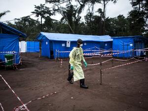 In this file photograph taken on June 13, 2017, a health worker walks at an Ebola quarantine unit in Muma, eastern Democratic Republic of Congo Four people have died from the hemorrhagic Ebola virus during a new outbreak in the Democratic Republic of Congo, officials said February 21, 2021. JOHN WESSELS / AFP
