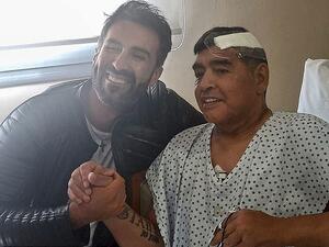  Maradona (right) underwent emergency brain surgery to remove a blood clot in November. (AFP)