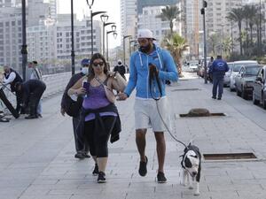A couple and their dog on the Beirut promenade 