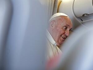 Pope Francis speaks to reporters during a news conference while in the air aboard the Alitalia papal plane on his flight back from Iraq