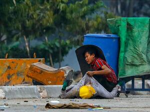 A protester holds onto the shirt of a fallen comrade