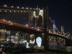 Images of Covid-19 Victims projected over the Brooklyn Bridge