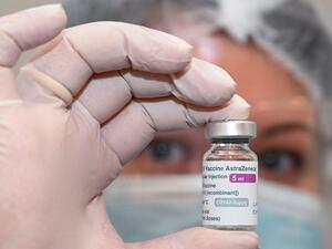 A nurse holds a vial of the Oxford-AstraZeneca vaccine 