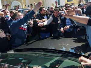 Angry protesters mob an MP's car outside the Salt hospital in Jordan 