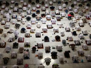 Muslim worshippers perform the evening Tarawih prayer during the fasting month of Ramadan around the Kaaba in the Grand Mosque 