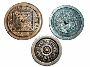 Made of bronze, the mirrors have intricate detail and ancient Chinese text