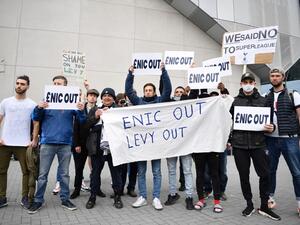 Fans hold posters reacting to the collapse of the planned creation of a European Super League, outside the Tottenham Hotspur Stadium in north London on April 21, 2021 (Photo: AFP)