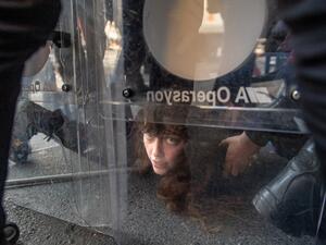 Turkish police detain a demonstrator in clash during May Day 