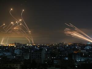 Rockets are seen in the night sky fired towards Israel from Beit Lahia in the northern Gaza Strip 