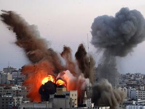 Smoke billows after an Israeli airstrike on Gaza City targeted the Ansar compound, linked to the Hamas movement, in the Gaza Strip on May 14, 2021. Israel pounded Gaza and deployed extra troops to the border as Palestinians fired barrages of rockets back, with the death toll in the enclave on the fourth day of conflict climbing to over 100