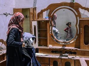 A Palestinian woman searches for the families belongings at their house, after it was destroyed by an Israeli airstrike, in the city of Rafah, in the southern Gaza Strip on May 16, 2021. Israeli strikes killed 33 Palestinians in the Gaza Strip, the worst daily death toll yet in the almost week-long clashes, as the UN Security Council prepared to meet amid global alarm at the escalating conflict. 