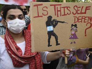 Demonstrators holding banners and placards take part in a protest rally against Israel's attacks on the Palestinian Gaza Strip in Lahore 