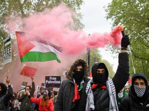 Pro-Palestine protesters set Israeli flags on fire outside the London embassy