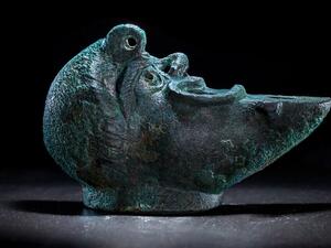 oil lamp shaped like grotesque face 