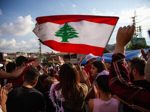 Protesters raise the Lebanese Flag