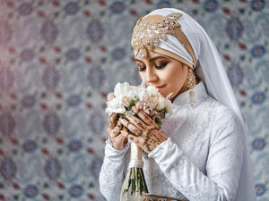 Muslim bride with jewelery in a headscarf hijab