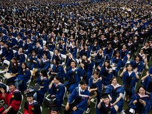 This photo taken on June 13, 2021 shows nearly 11,000 graduates, including more than 2000 students who could not attend the graduation ceremony last year due to the Covid-19 