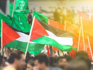 concept of Palestinian flags held by Palestinian people  