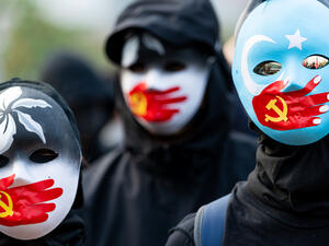 A group of protestors wear masks symbolizing the Communist Party of China's silencing of Uyghur Muslims and the Hong Kong pro-democracy movement at a rally in Hong Kong. (Shutterstock/ File Photo) Countries are worried about over treatment of Uyghur Muslims.