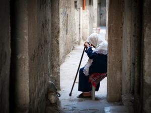 A Palestinian woman sits in the old city of the West Bank city of Hebron