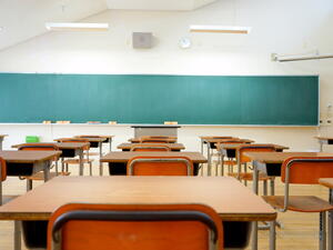 School classroom with school desks and blackboard