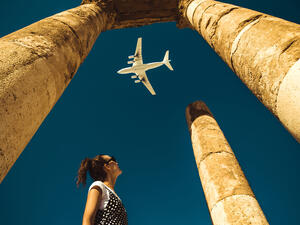 Young woman look at airplane dreaming about vacation