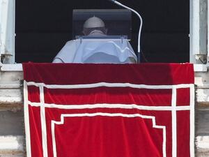 Pope Francis turns after delivering the Sunday Angelus prayer from the window of his study overlooking St.Peter's Square at the Vatican 