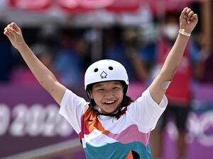 Japan's Momiji Nishiya celebrates after performing a trick during the skateboarding women's street final of the Tokyo 2020 Olympic Games at Ariake Sports Park in Tokyo 