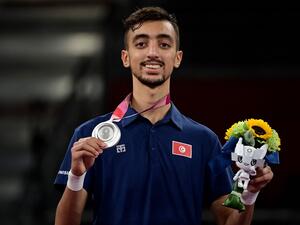 Tunisia's Mohamed Khalil Jendoubi celebrates with his silver medal on the podium after winning the taekwondo men's -58kg gold medal bout during the Tokyo 2020 Olympic Games at the Makuhari Messe Hall in Tokyo on July 24, 2021. (Photo: AFP)