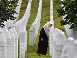  Bosnian Muslim woman Mejra Djogaz, 71, survivor of Srebrenica 1995 massacre, kisses her sons' tombstones, Omer, 19, and Munib, 21, her two sons killed in the massive killing of Srebrenica 