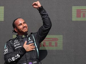 Race winner Mercedes' British driver Lewis Hamilton celebrates on the podium after the Formula One British Grand Prix motor race at Silverstone motor racing circuit in Silverstone, central England on July 18, 2021. (Photo: AFP)