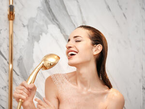 Young beautiful woman taking shower in bathroom