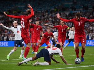 England's forward Raheem Sterling (C) falls on the ground which led to the awarding of a penalty during the UEFA EURO 2020 semi-final football match between England and Denmark at Wembley Stadium in London on July 7, 2021. (Photo: AFP)