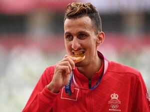 First-placed Morocco's Soufiane El Bakkali celebrates on the podium with his gold medal after competing in the men's 3000m steeplechase event during the Tokyo 2020 Olympic Games at the Olympic Stadium in Tokyo on August 3, 2021. (Photo: AFP)