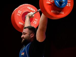 Syria's Man Asaad reacts in the men's +109kg weightlifting competition during the Tokyo 2020 Olympic Games at the Tokyo International Forum in Tokyo on August 4, 2021. (Photo: AFP)