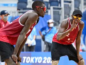 Qatar's Ahmed Tijan (R) gestures beside partner Cherif Younousse in their men's beach volleyball bronze medal match between Latvia and Qatar during the Tokyo 2020 Olympic Games at Shiokaze Park in Tokyo on August 7, 2021. (Photo: AFP)