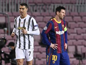 Juventus' Portuguese forward Cristiano Ronaldo (L) walks past Barcelona's Argentinian forward Lionel Messi during the UEFA Champions League group G football match between Barcelona and Juventus at the Camp Nou stadium in Barcelona on December 8, 2020. (Photo: AFP)