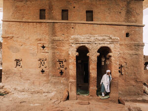  Orthodox Christian Ethiopian monk behind Lalibela church Bete Maryam Alem on May 1st. 2019 in Lalibela, Ethiopia