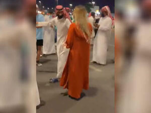 الشقراء ذات العباءة البرتقالية
