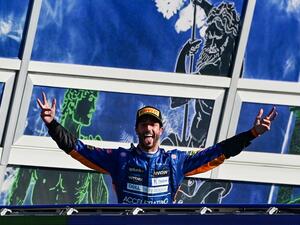 Winner McLaren's Australian driver Daniel Ricciardo celebrates on the podium after the Italian Formula One Grand Prix at the Autodromo Nazionale circuit in Monza, on September 12, 2021. (Photo: AFP)