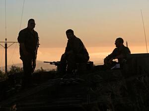 Israeli soldiers looking towards Lebanon 