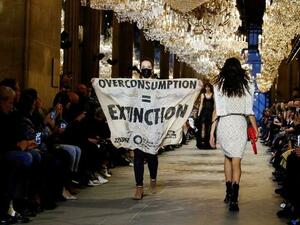 Climate change protester crashes Louis Vuitton catwalk show in Paris