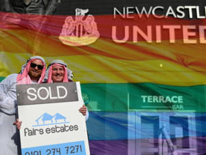 Newcastle fans celebrating Saudi deal