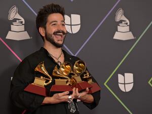 Colombian singer Camilo poses with his awards in the press room during the 22nd Annual Latin Grammy awards at the MGM Grand Arena in Las Vegas, Nevada, November 18, 2021. (Photo by Bridget BENNETT / AFP) Colombian singer Camilo