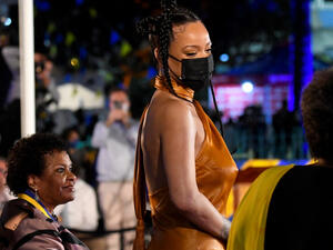 The Fenty Beauty founder chose to go braless as she rocked an orange silk dress and strappy heels.  The Fenty Beauty founder chose to go braless as she rocked an orange silk dress and strappy heels.